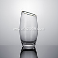 Slanted tumbler glass with gold rim
